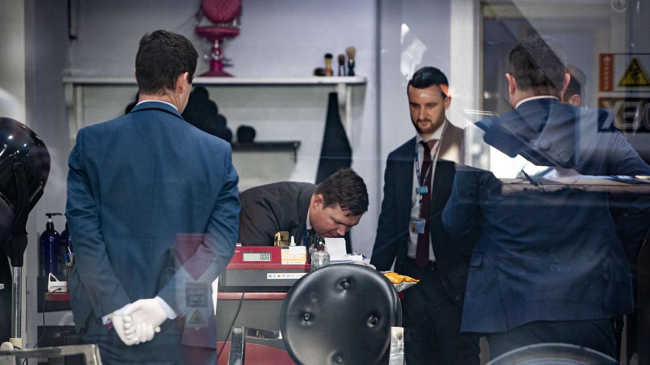 Police search and collect evidence from the hair salon. Picture: Julian Andrews