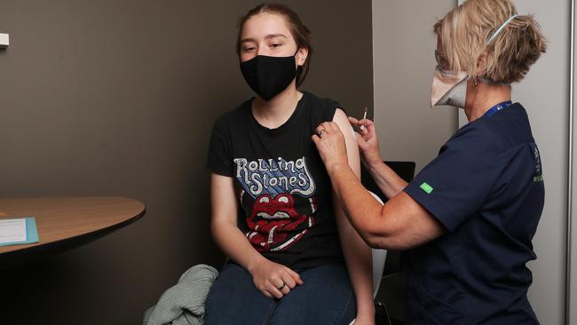 Isabella Wills with registered nurse Belinda Coad. Isabella Wills 17 of Hobart who had her covid-19 vaccination booster at the Hobart City Vaccination Centre. Teenagers 16-17 are now eligible to have their covid-19 vaccination booster. Picture: Nikki Davis-Jones