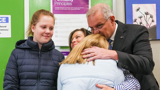 Prime Minister Scott Morrison and wife Jenny Morrison hug their children after voting at Lilli Pilli Public School in the seat of Cook.