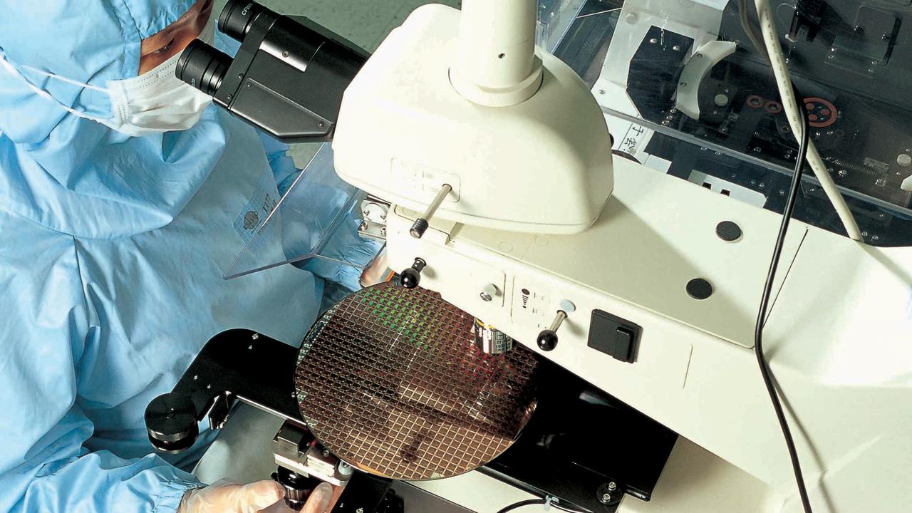 An operator inspects new computer chips on the production line at TSMC in Taiwan. Source: Taiwan Semiconductor Manufacturing Co Ltd