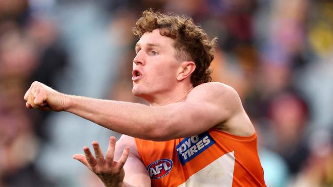 MELBOURNE, AUSTRALIA - JULY 14: Tom Green of the Giants handballs during the round 18 AFL match between Richmond Tigers and Greater Western Sydney Giants at Melbourne Cricket Ground, on July 14, 2024, in Melbourne, Australia. (Photo by Robert Cianflone/Getty Images)