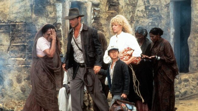 Harrison Ford, Jonathan Ke Quan and Kate Capshaw are led through a temple in a scene from the movie. Picture: Paramount/Getty Images