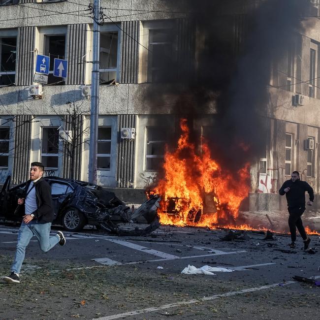 Cars burn in central Kyiv, Ukraine, after missile strikes on Monday. Picture: Reuters