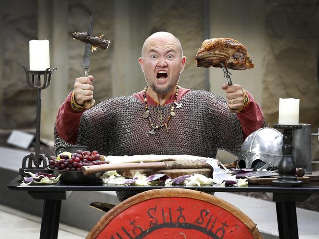 Volrath the Viking, aka Kevin Wolrath, tucks into some lunch Viking style at the Melbourne Museum. Picture: David Caird