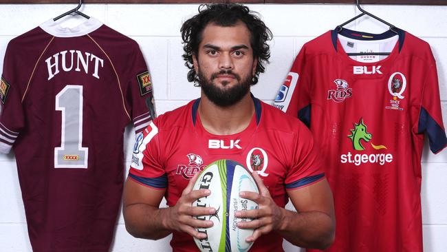 Hunt with his Maroons and Reds jerseys. Picture: Darren England