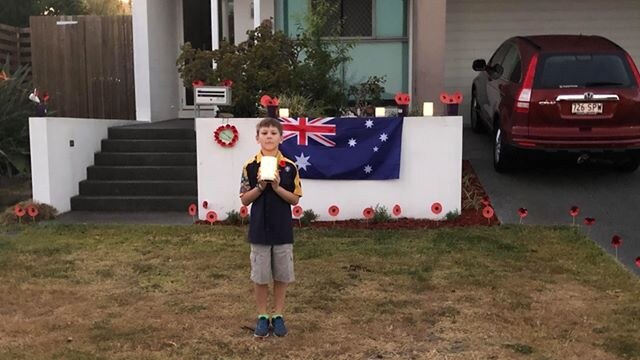 Xavier Sang with his Anzac Day memorial in Cannon Hill. He also made poppies for his neighbours.