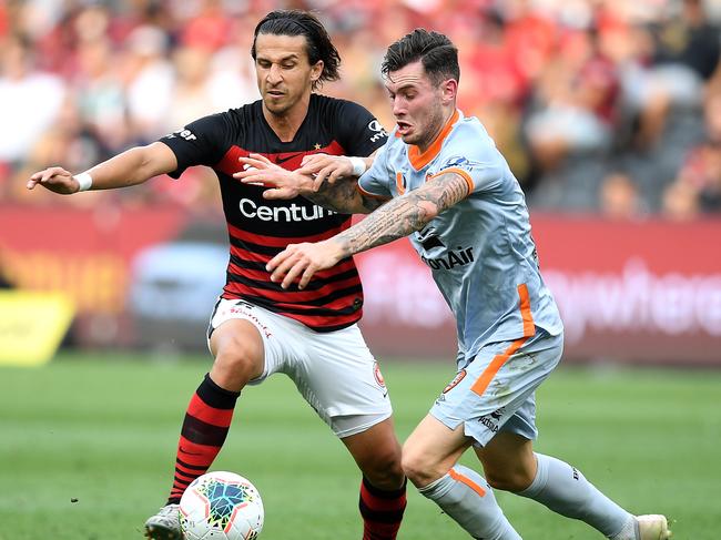 Wanderers fullback Daniel Georgievski (left) competes for the ball with Roar midfielder Aiden O’Neill. Picture: AAP