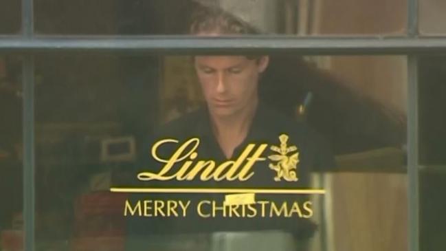 Tori Johnson, who was killed in the Sydney siege, pictured at the window of the Lindt Cafe. Picture: Channel Seven