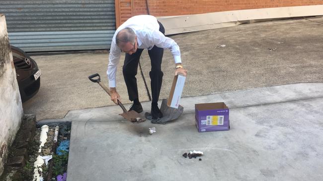 Real Estate agent Tim Simpson cleans human poo left in the laneway behind his Ashfield business.