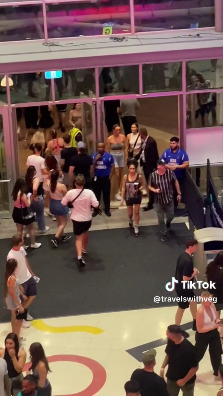 The man flees security, slipping past the crowd and out the arena doors after dancing on the car. Picture: Supplied / TikTok