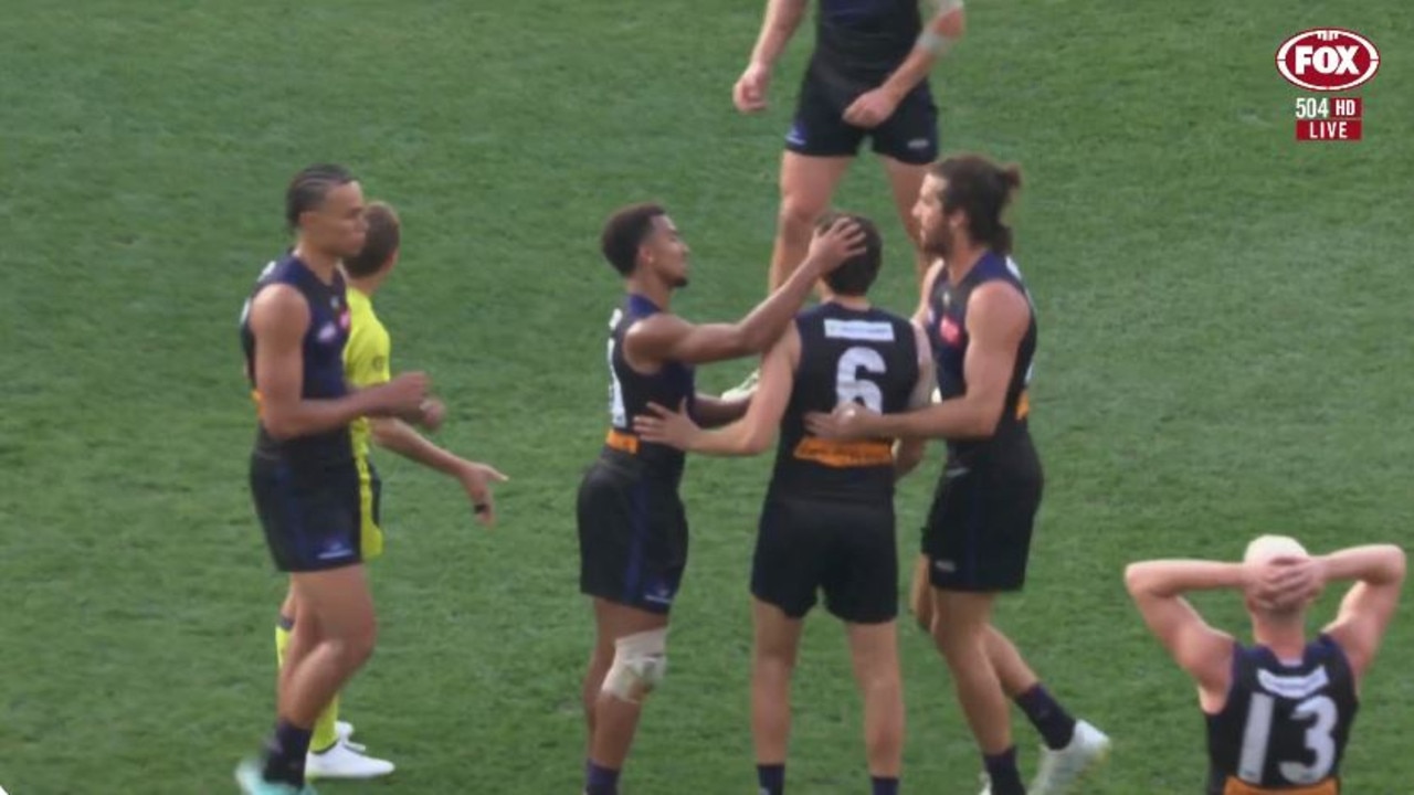 Jordan Clark (No. 6) surrounded by teammates after being hit with the free kick for dissent. Photo: Fox Sports