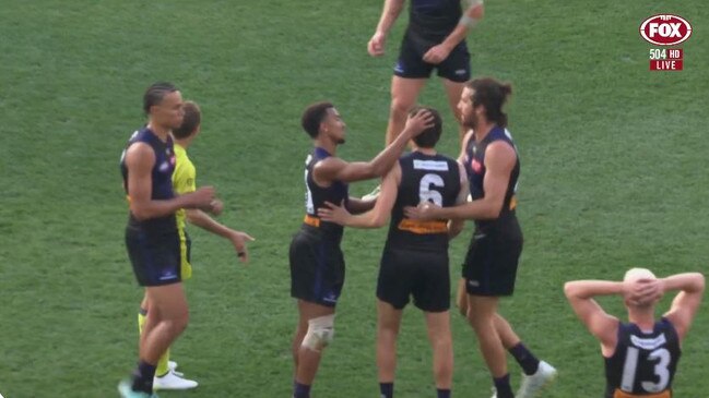 Jordan Clark (No. 6) surrounded by teammates after being hit with the free kick for dissent. Photo: Fox Sports
