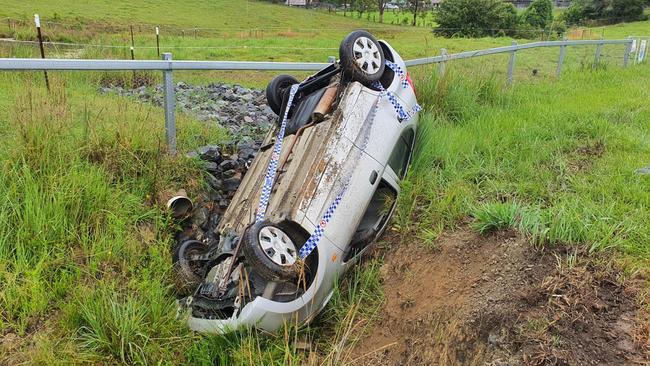 A car is left upturned after crashing in a ditch at the front of Tamara Haldon’s Coramba Road property.