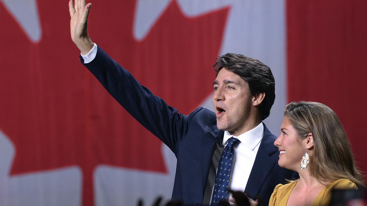 Liberal leader Justin Trudeau and wife Sophie Gregoire Trudeau wave as they go on stage at Liberal election headquarters in Montreal on Monday. Picture: Ryan Remiorz/The Canadian Press via AP.