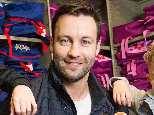 The new ambassador for the Alannah & Madeline Foundation is Jimmy Bartel. Jimmy packs Buddy Bag's with Sienna, 10, and Mason, 5. Picture: Mark Stewart