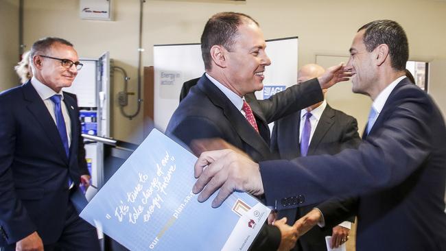 Federal Energy Minister Josh Frydenberg and SA Energy Minister Tom Koutsantonis go to embrace in happier times. Taken just before Premier Jay Weatherill (left) launched a verbal attack on Mr Frydenberg. Picture: Mike Burton