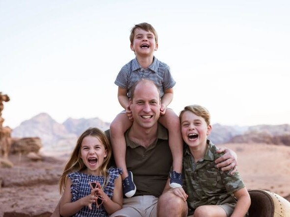 Prince William laughs with kids George, Charlotte and Louis in the official Father's Day snap. Picture: Kensington Palace