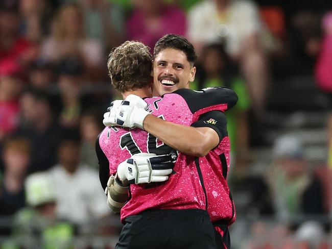 SYDNEY, AUSTRALIA - DECEMBER 21: Ben Dwarshuis of the Sixers celebrates hitting the winning runs with Jordan Silk of the Sixers during the BBL match between Sydney Thunder and Sydney Sixers at ENGIE Stadium, on December 21, 2024, in Sydney, Australia. (Photo by Cameron Spencer/Getty Images)