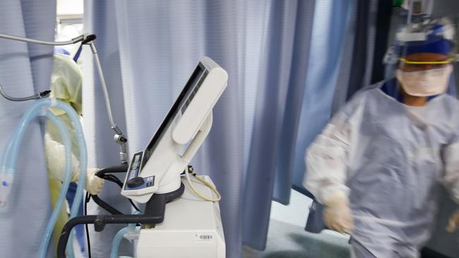 A US nurse pulls a ventilator into an exam room. Picture: AP