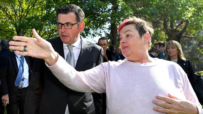 A local resident directs the attention of Victorian Premier Daniel Andrews towards the drug overdose scene. Picture: Joe Castro/AAP