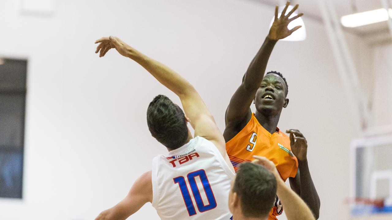 Thon Angui (right) of Westridge Fruit and Veg Warriors and William Mitchell of Washed on James Mustangs at the tip-off in Toowoomba Basketball League round five at Clive Berghofer Arena, St Mary's College, Monday, November 23, 2020. Picture: Kevin Farmer