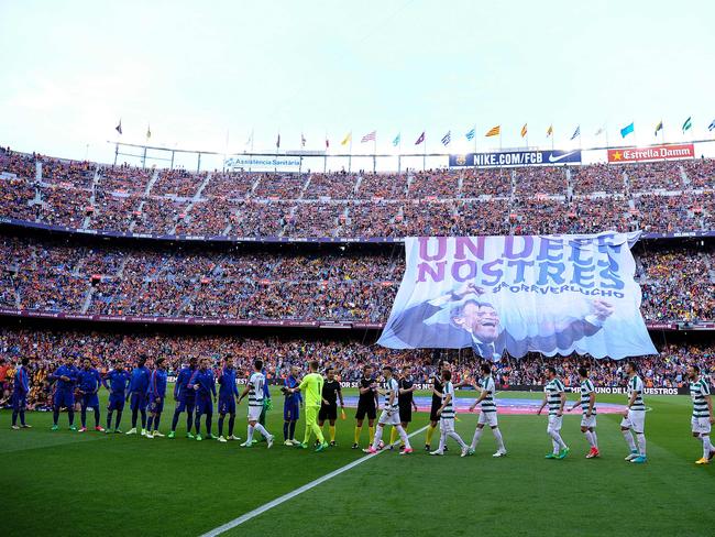 Both teams cheer each other as a big banner as a tribute to Barcelona's coach Luis Enrique, reading in Catalan "For ever, one of ours" is unfolded.