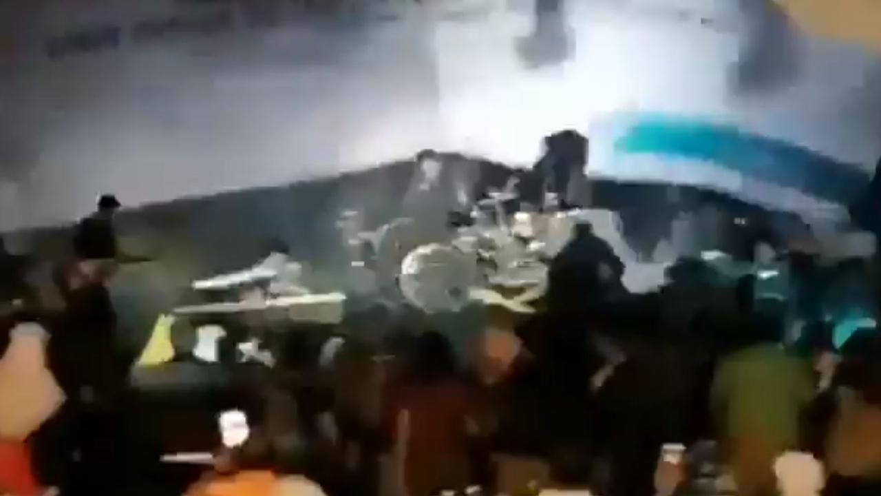 The still from a video shows the moment a massive wall of water smashed into a stage while a band was performing.