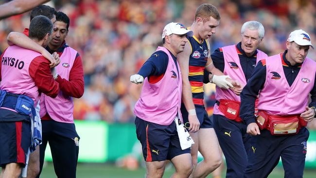 Tom Lynch and Alex Georgiou are helped off the ground by trainers. Picture: SARAH REED.