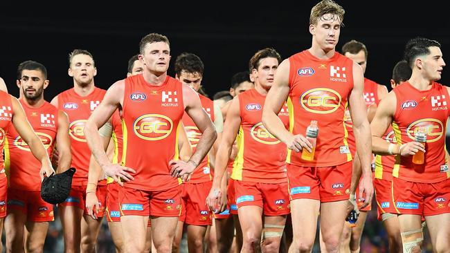 Dejected Gold Coast players leave the ground on Saturday. Picture: Getty Images