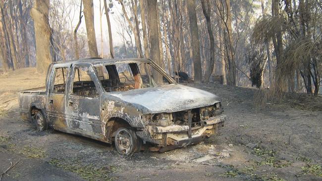 A destroyed car on the Thompson Drive Estate at Tathra, which sustained serious damage during the fire. Picture: David Neyle