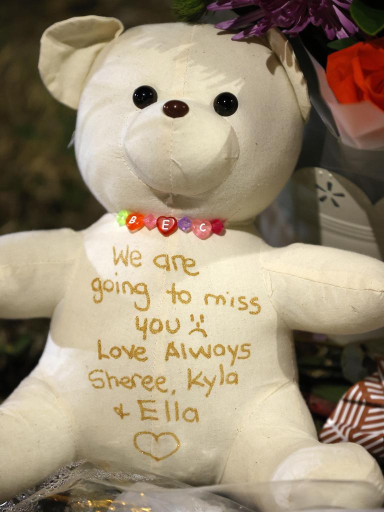 A teddy bear left for Rebecca Mullen with floral tributes.