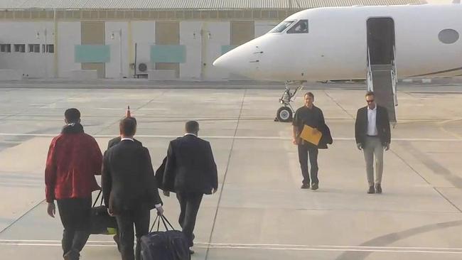 US basketball star Brittney Griner (left, red jacket) and notorious Russian arms dealer Viktor Bout (second from right) are exchanged on the tarmac in Abu Dhabi in an historic prisoner swap.