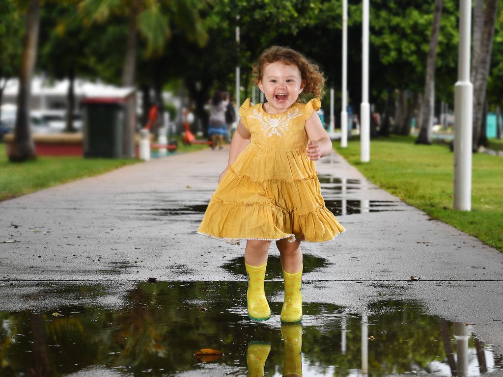 Sybella Johnston, 2, from Bushland Beach enjoying the wet weather. Picture: Shae Beplate.