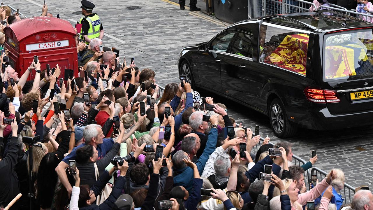 Members of the public observe the vehicle carrying her coffin. Picture: Oli Scarff/AFP