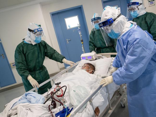 Medical staff transfer a patient infected by the coronavirus at a hospital in Wuhan in China's central Hubei province. Picture: AFP