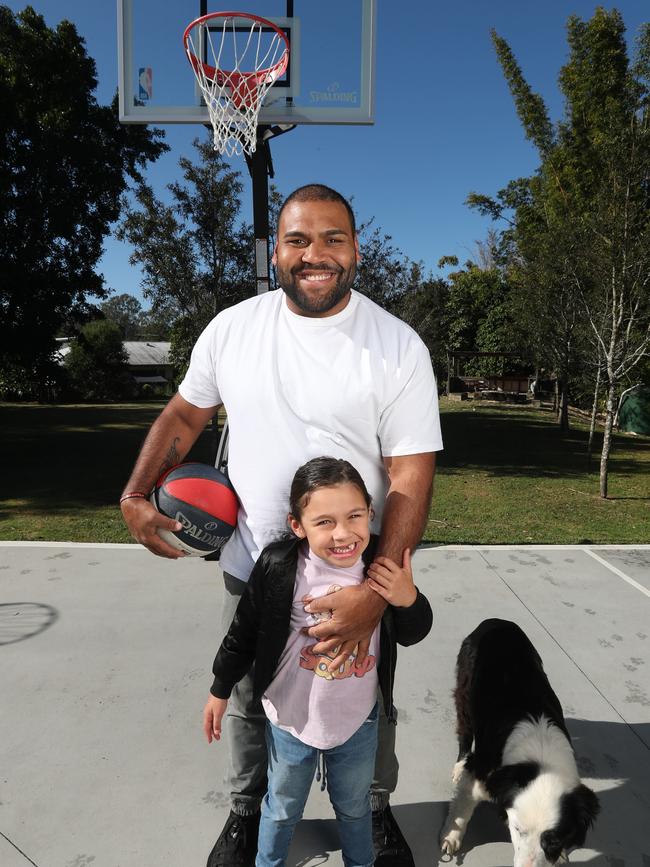 Sam Thaiday with his dog Winkie and daughter Elsie. Pic Annette Dew