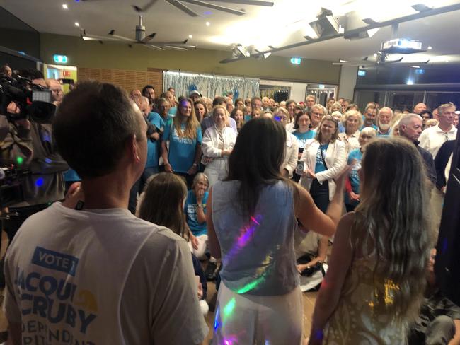 Independent candidate for the Pittwater by-election, Jacqui Scruby, celebrates her likely victory on Saturday night with her husband Michael and their two daughters, and her supporters, at the Avalon Beach Surf Life Saving Club. Picture: Jim O’Rourke