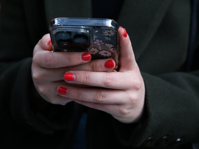 SYDNEY, AUSTRALIA - Newswire Photos - JULY 25 2023: People are seen on their mobile phones during lunch time in the Sydney CBD. Picture: NCA Newswire / Gaye Gerard