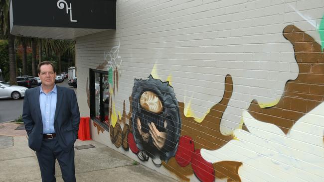 Cr Simon Menzies is upset with the incomplete wall mural in Canrobert St, on the wall of cafe Heirloom Espresso in Mosman. Picture: Annika Enderborg