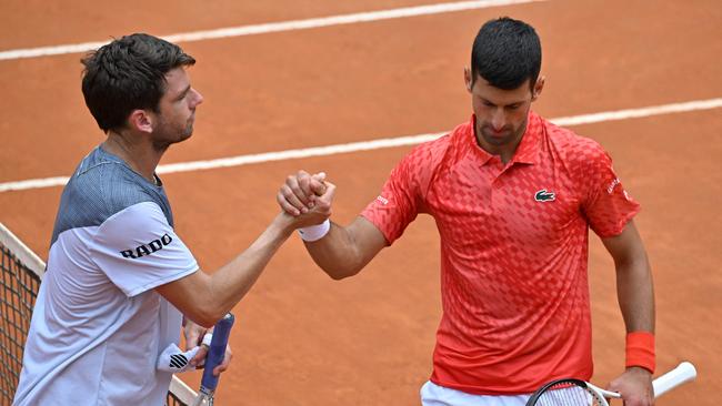 The frosty post-game exchange. (Photo by Tiziana FABI / AFP)