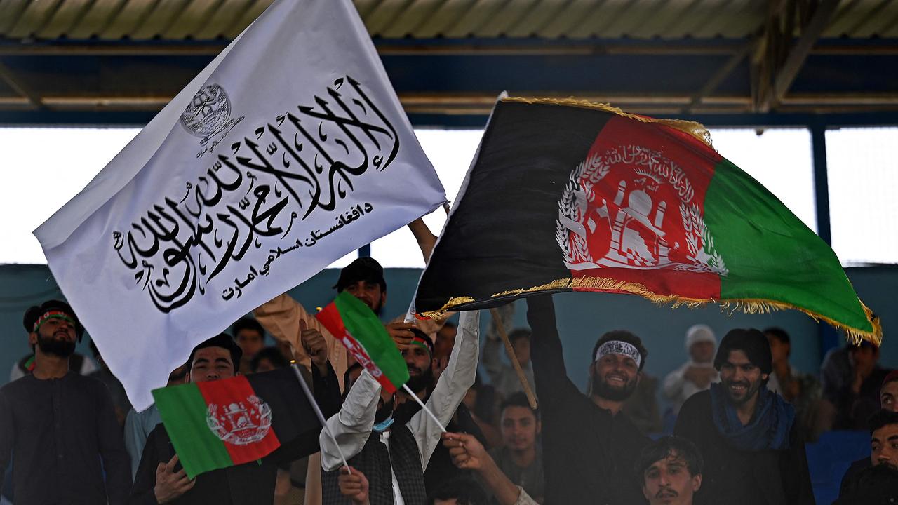 Spectators wave Afghanistan's and Taliban flags at a T20 game in Kabul. Picture: Aamir Qureshi / AFP