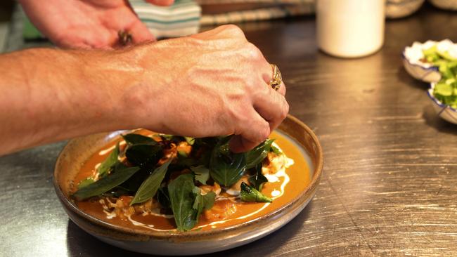 Chef Ben Bertei plates the coconut and turmeric curry of Moreton Bay bug, Asian celery and Kaffir lime, at LongTime, Fortitude Valley. Picture: Anthony Weate