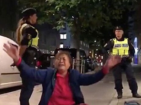 A Chinese tourist cries after being removed from a hostel in Stockholm, Sweden, Sept