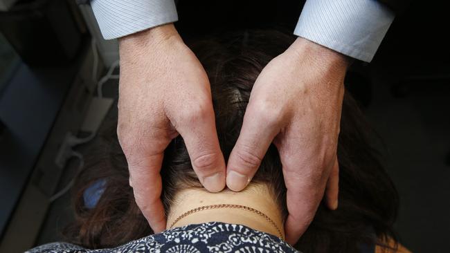 Melbourne Headache Centre headache consultant and director Roger O'Toole treats Cindy Stephenson. Picture: David Caird