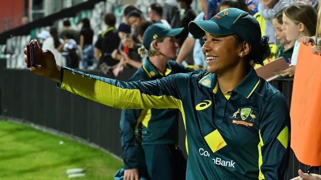 MACKAY, AUSTRALIA - SEPTEMBER 22: Alana King of Australia takes a selfie with Megan Schutt and fans during game two of the Women's T20 International Series between Australia and New Zealand at Great Barrier Reef Arena on September 22, 2024 in Mackay, Australia. (Photo by Albert Perez/Getty Images)