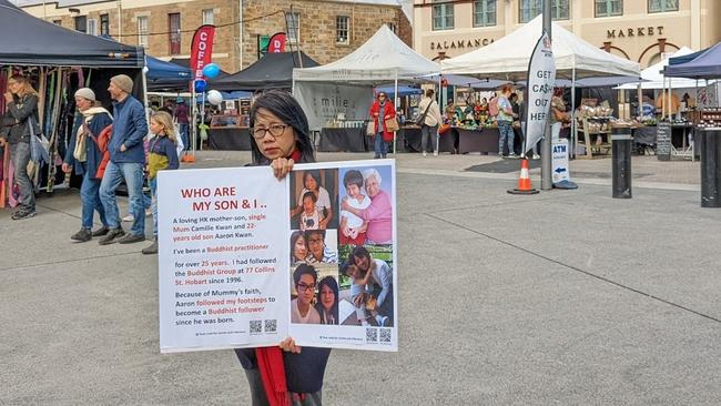 Hong Kong-based mother Camille Kwan protesting in Salamanca Place, Hobart, to raise awareness about her son and the Tasmanian Chinese Buddhist Academy of Australia.