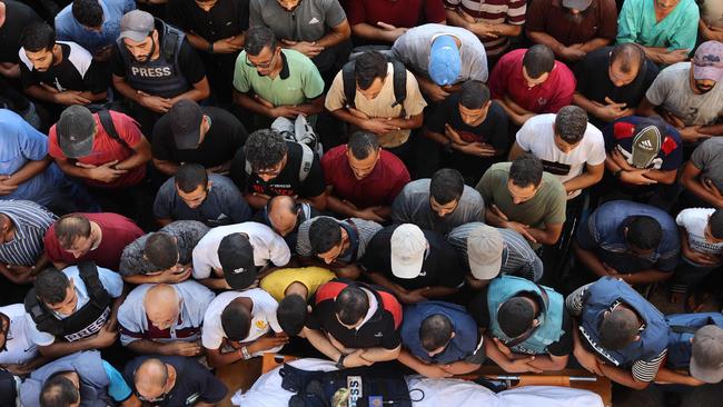 Mourners and colleagues recite a prayer over the body of Al-Jazeera Arabic journalist Ismail al-Ghoul this week. Picture: AFP