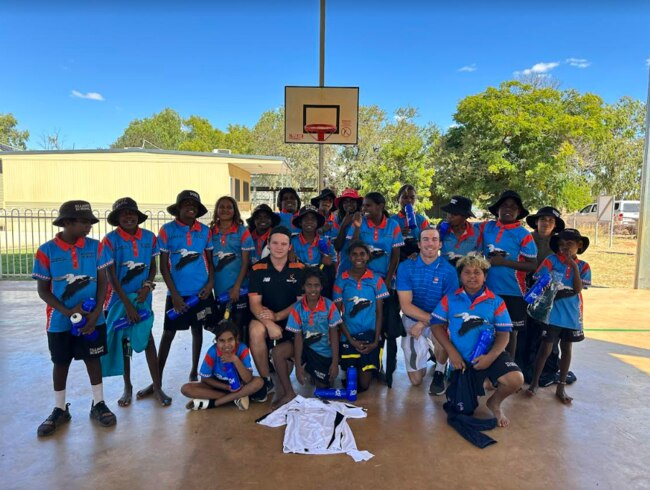 Golf Australia’s Brodie Morcom (centre right) and Hockey NT’s Dominic Sloane (centre left) with students at the remote Elliott School in the Northern Territory. Picture: Supplied