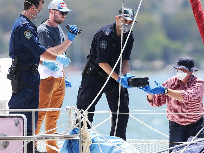 Police remove the massive drug haul from the yacht in Lake Macquarie last week. Picture: Peter Lorimer