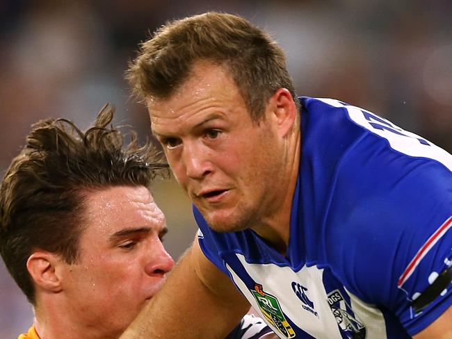 PERTH, AUSTRALIA - MARCH 10:  Josh Morris of the Bulldogs fends off a tackle during the round one NRL match between the Canterbury Bulldogs and the Melbourne Storm at Optus Stadium on March 10, 2018 in Perth, Australia.  (Photo by Paul Kane/Getty Images)